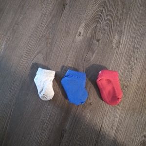 3 socks, 2 bottles and baby bag